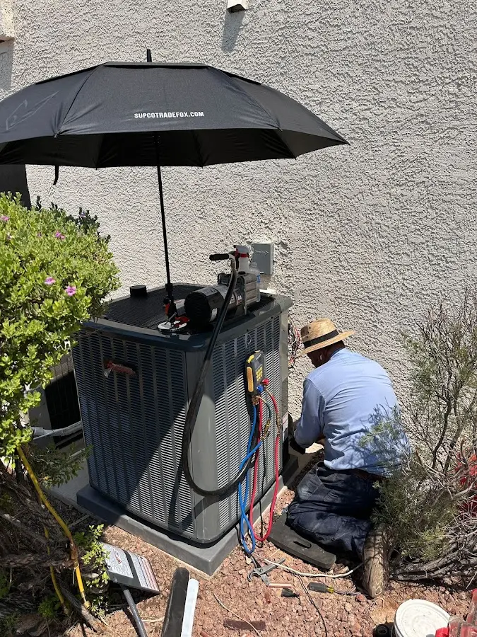 HVAC technician performing outdoor AC maintenance in Colusa